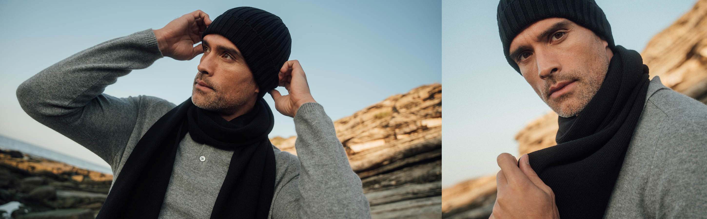 Accessoires für Herren Ein Mann steht draußen und trägt einen schwarzen Schal und die passende Mütze von FALKE.